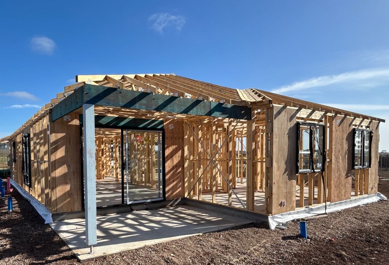 Melbourne house and land package under construction with timber frame and roof trusses in a growth-corridor estate